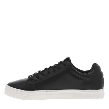Tennis en cuir noirs à semelle blanche avec un...