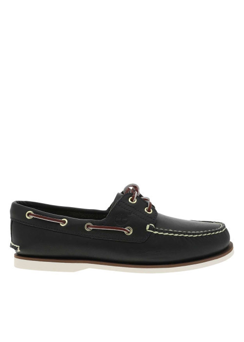 Mocassins en cuir bleus à semelle plate avec des œillets dorés sur le pourtour