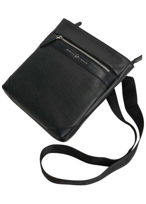 Sacoche noire unie avec une bandoulière ajustable et une fermeture zippée