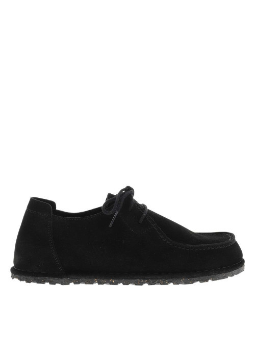 Mocassins en cuir noirs à semelle plate avec des surpiqûres sur l'empeigne