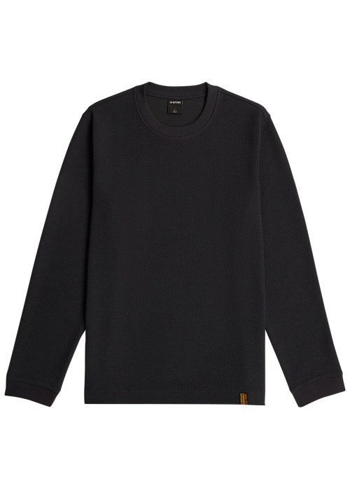 Pull noir à coupe droite pourvu d'un col rond...