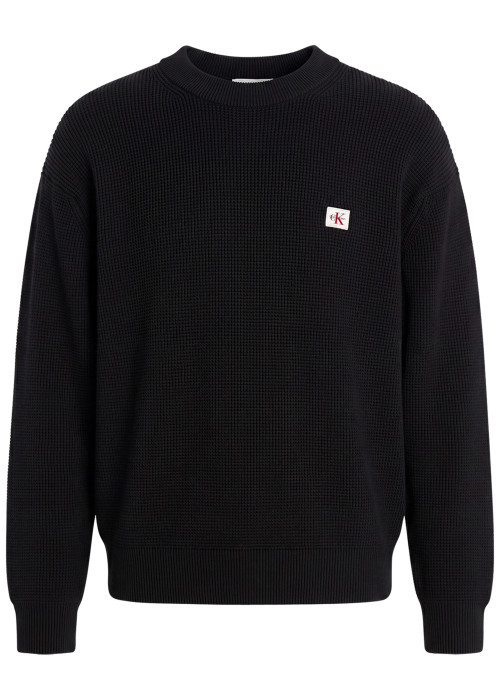 Pull en coton noir à coupe droite pourvu d'un col rond et de manches longues